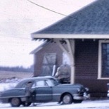 Vernon River 1967. Photographer unknown. It looks like the door is removed at this point; too bad the car is in the way. The proportions of the removed door seem correct for it to be resting on the ground right where the car's roof is. That would indicate that the earth is built up to the foundation's top.